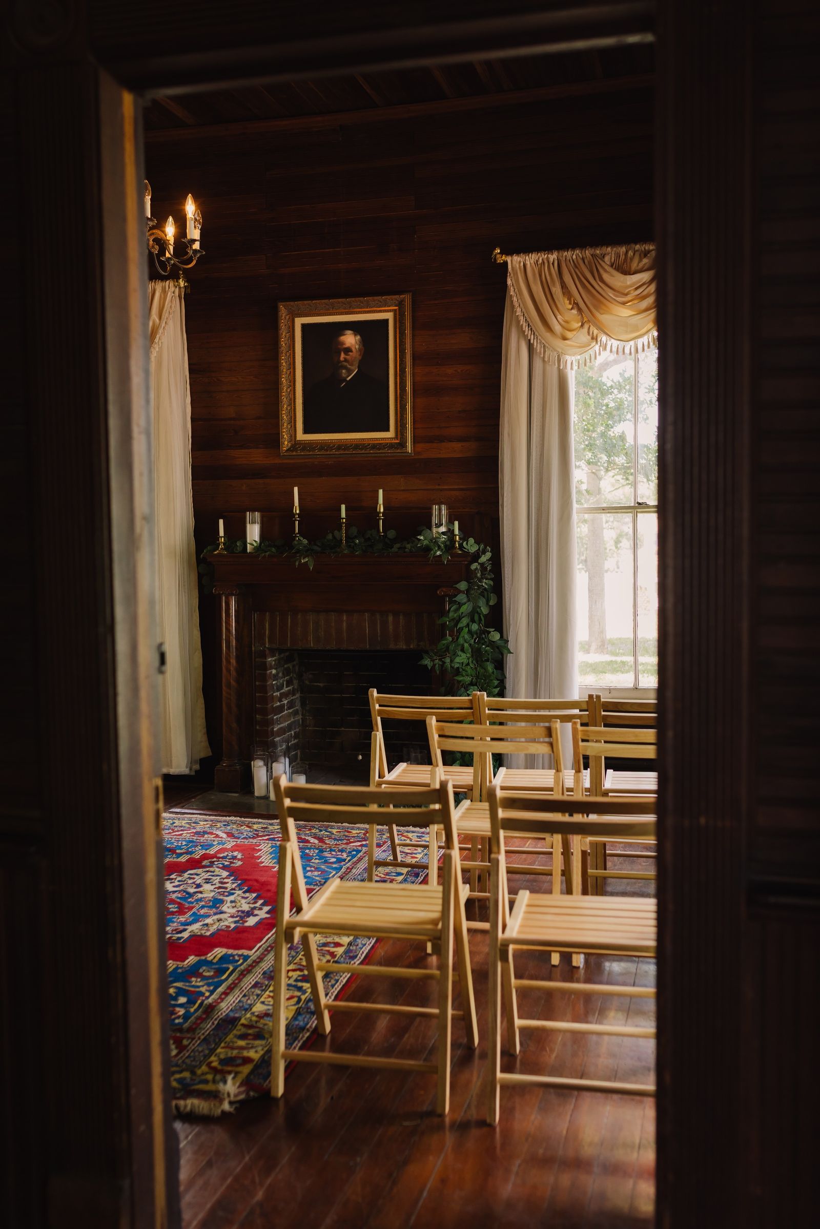 Chairs set for a ceremony by the fireplace