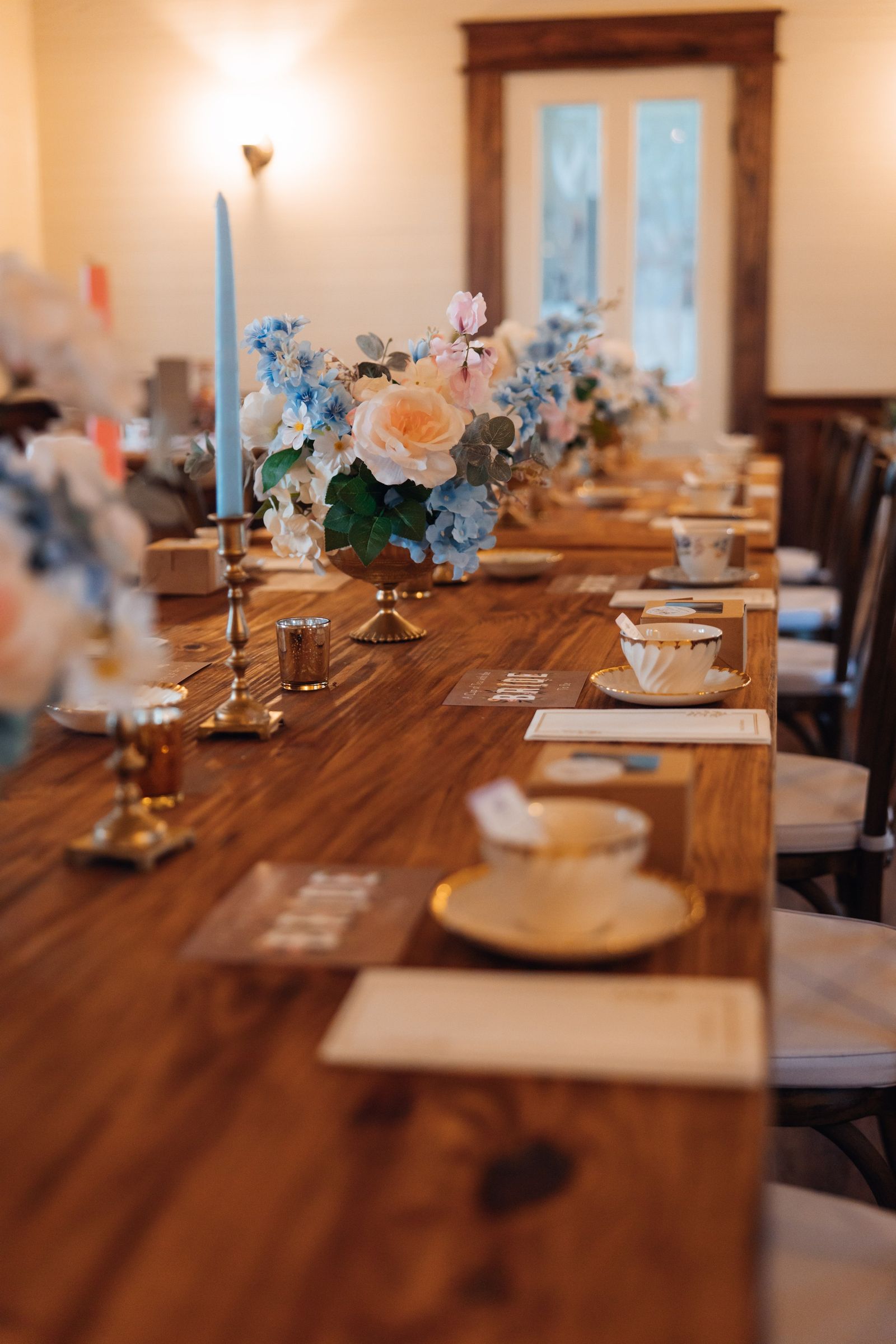 A long table set with candles and flowers