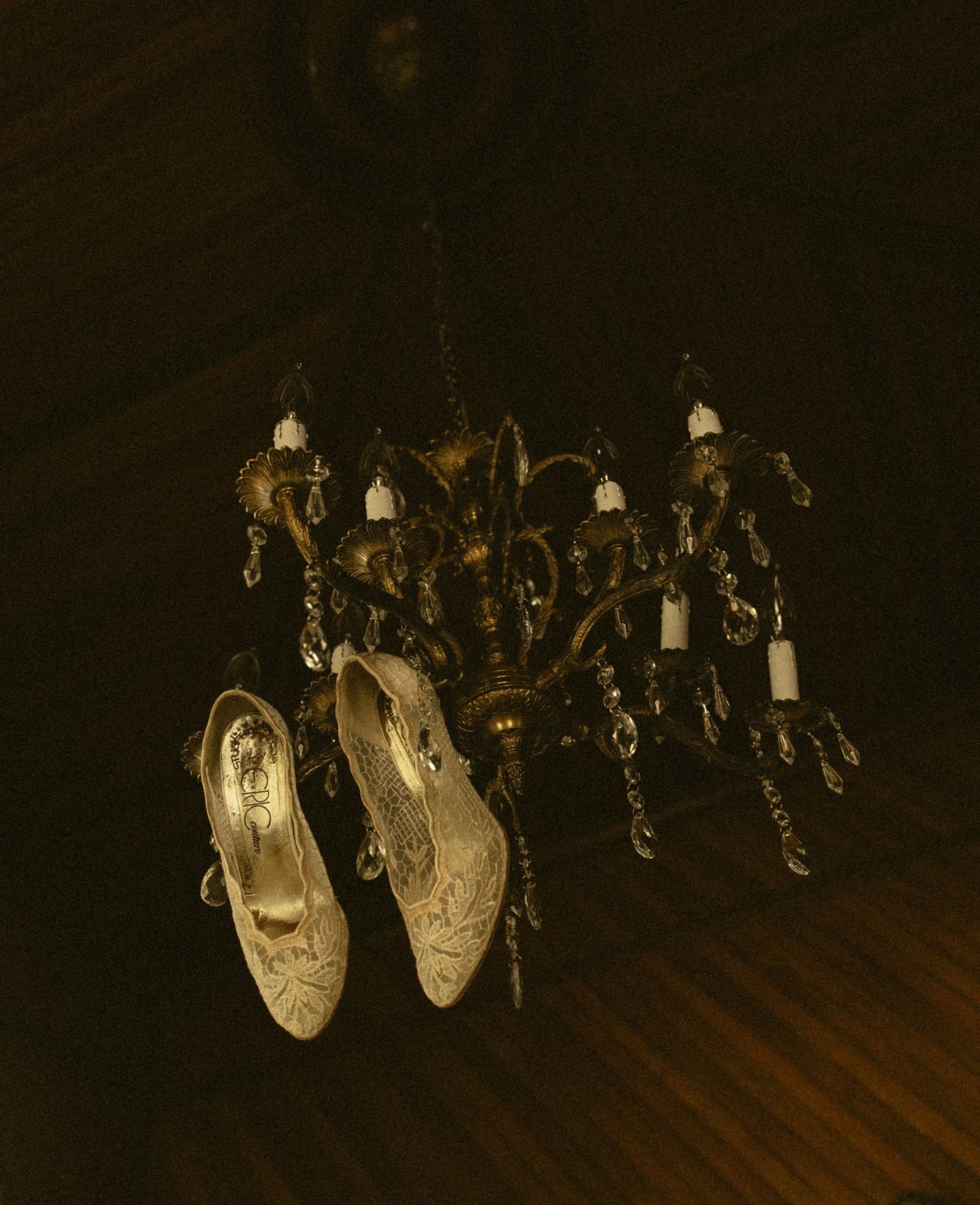 Shoes hanging from the chandelier